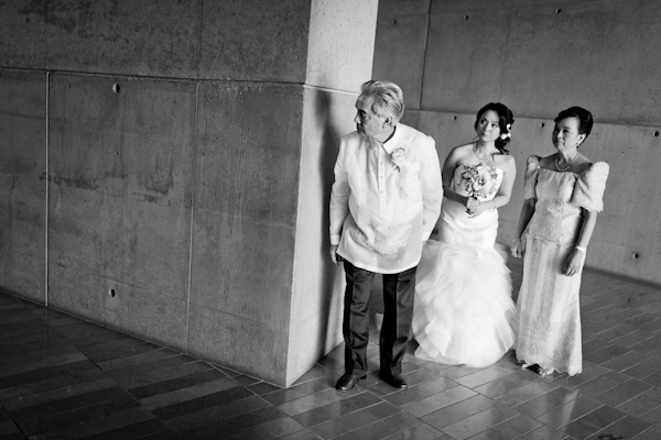 black and white photo of bride waiting with parents before ceremony entrance - photo by New Mexico based wedding photographers Twin Lens Images